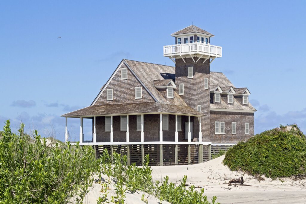 Wooden beach house with observation tower.