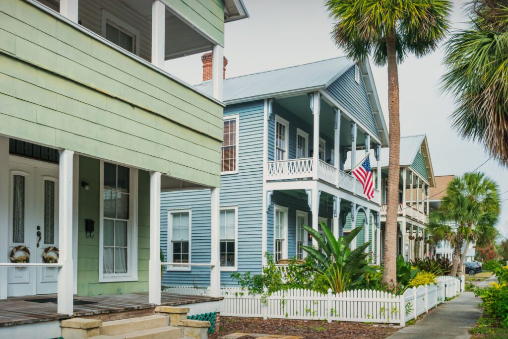Colorful houses with American flag and palm trees.